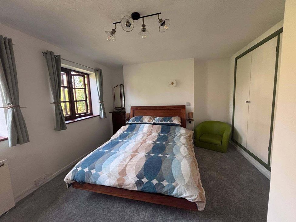 A bedroom with a bed and a chair at the property in location