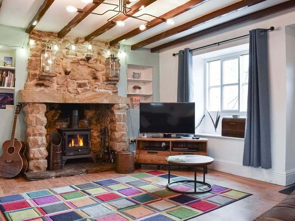 A living room with a fireplace and television