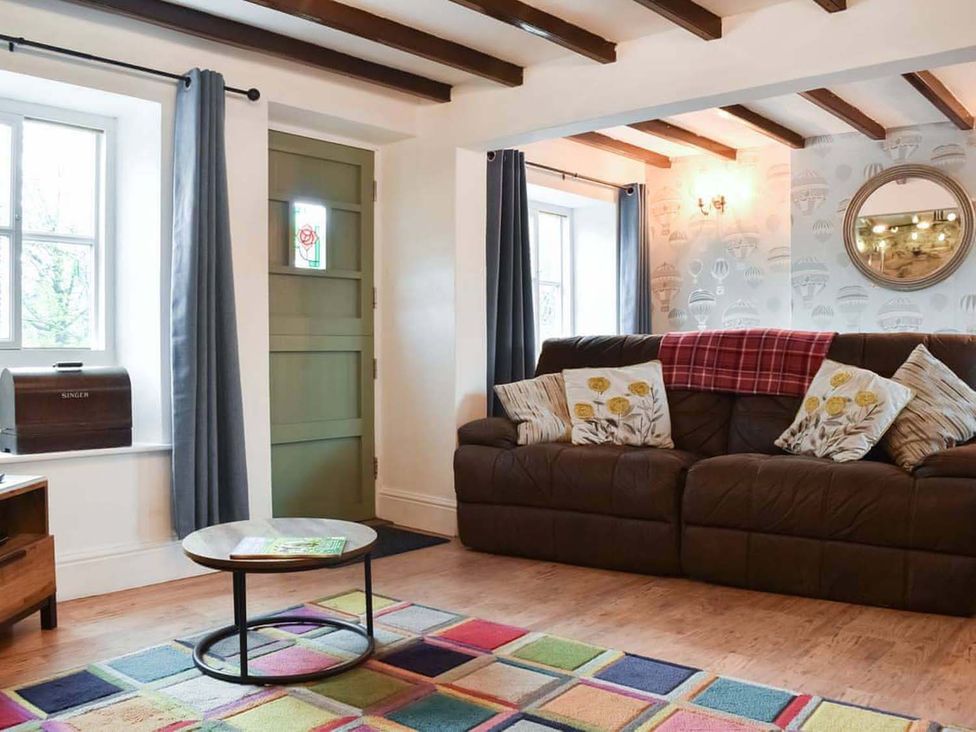 A living room with a sofa and coffee table at The Old Barn in Manchester
