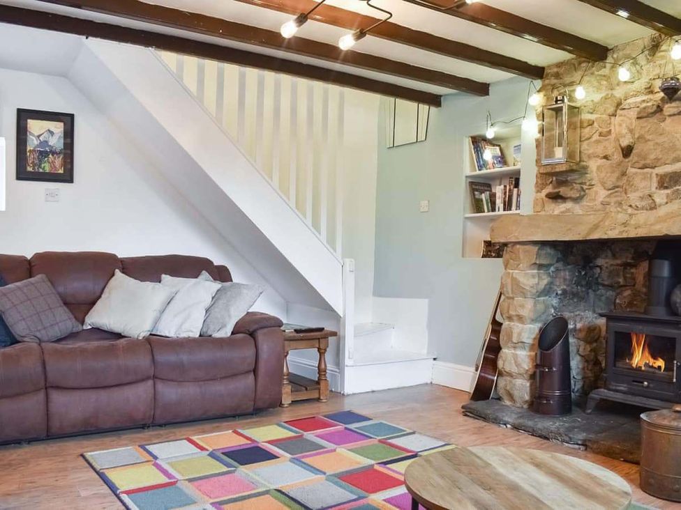 A living room with a couch and a fireplace at The Old Barn in Manchester