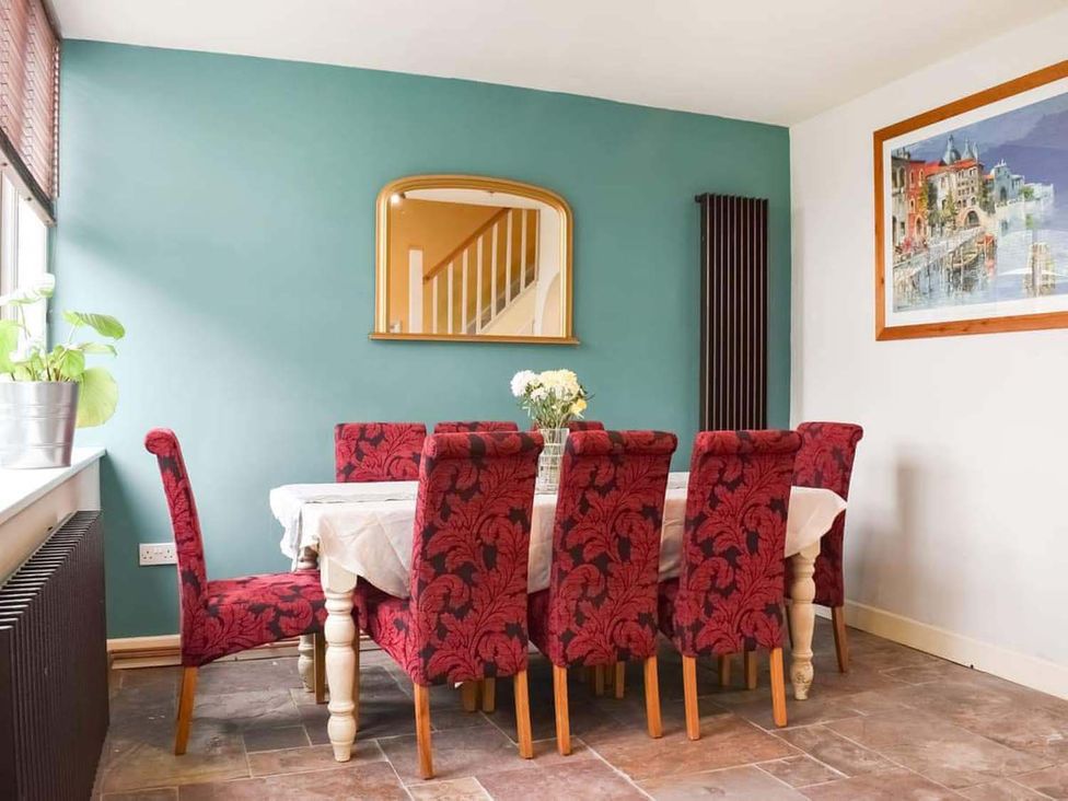 A dining room with a table and chairs at The Old Barn in Manchester