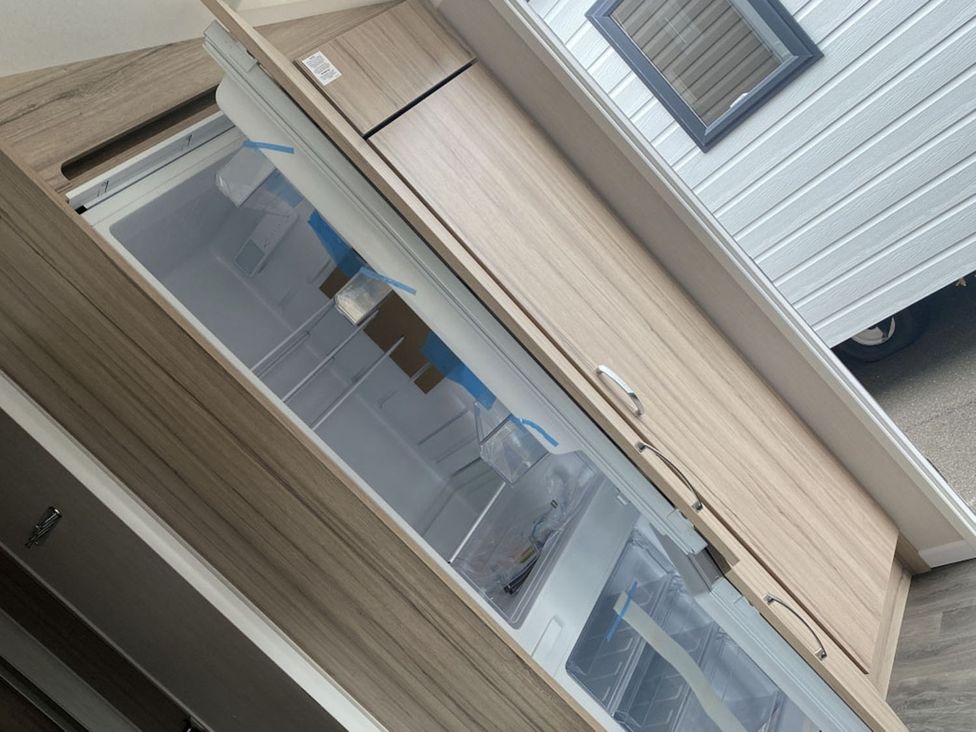 A refrigerator with a freezer compartment in a kitchen at 