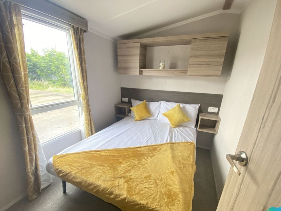 A bedroom with a bed and shelf at The Old Barn in Builth Wells