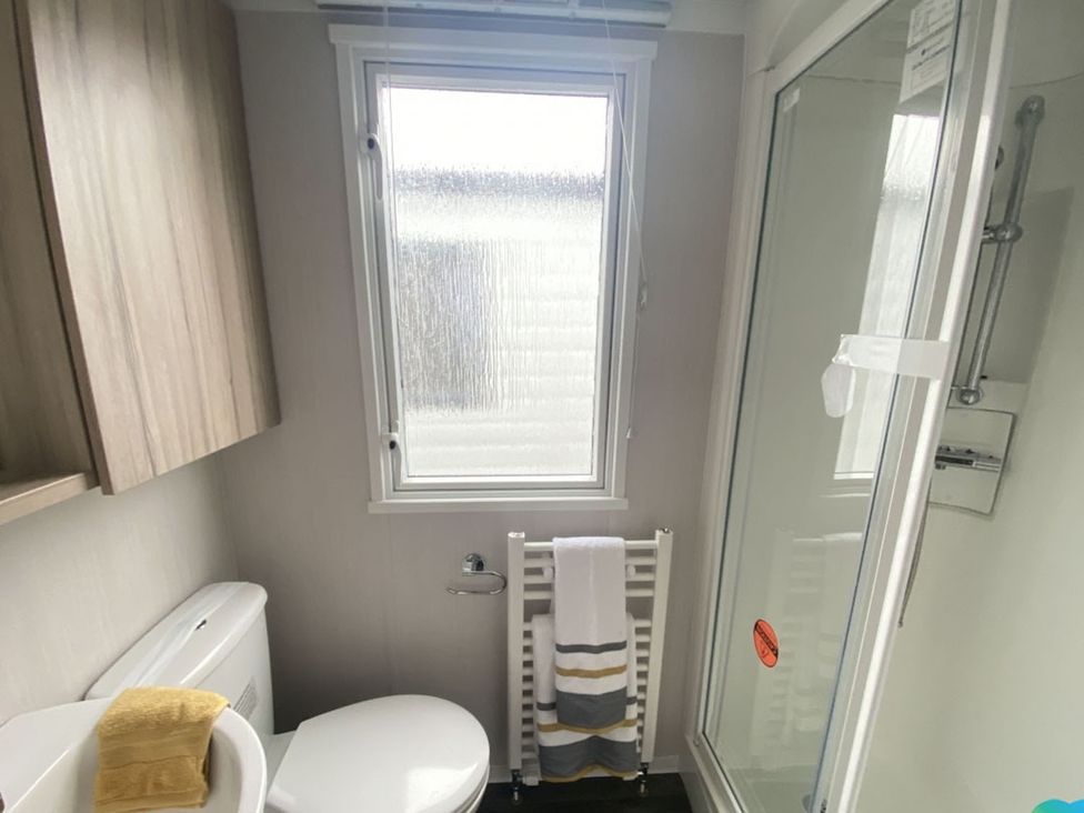 A bathroom with a shower and toilet at The Old Barn in Builth Wells