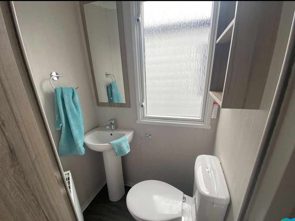 A bathroom with a sink and toilet at The Old Barn in Builth Wells
