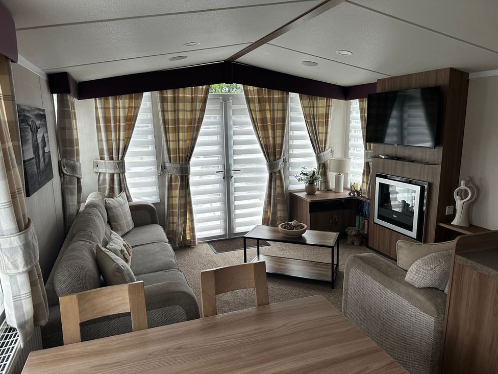 A living room with a sofa and television at a beach house