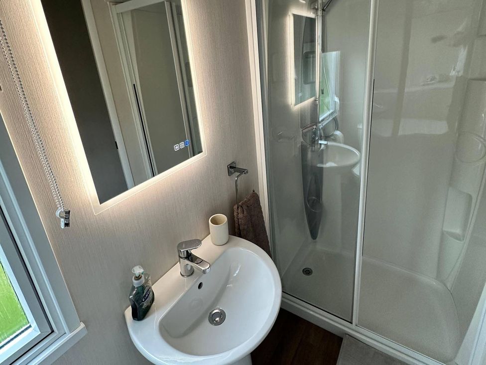 A bathroom with a sink and shower at The Old Barn in Manchester