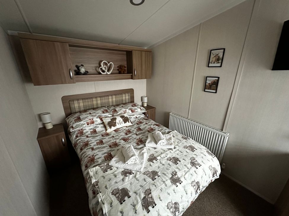 A bedroom with a bed and bedside tables at The Old Barn in Manchester