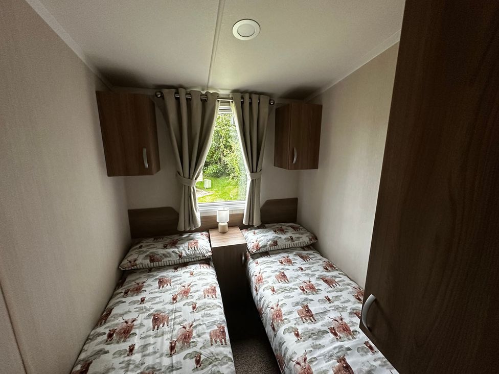 A bedroom with two beds and a window at a property