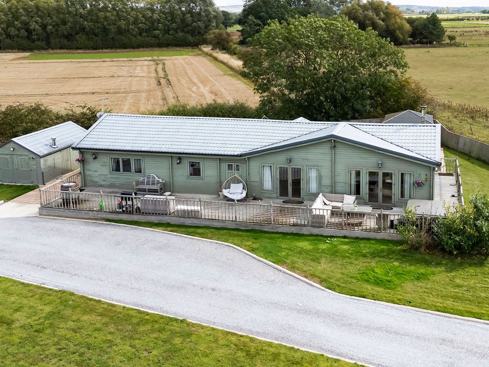 A house with a deck and garden at a property in an outdoor setting