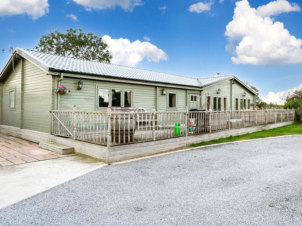 An outdoor area with a deck and house at the property