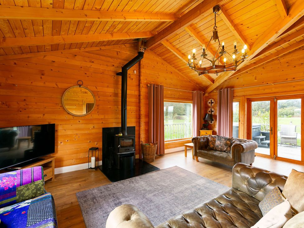 A living room with a fireplace and a television at the property in location
