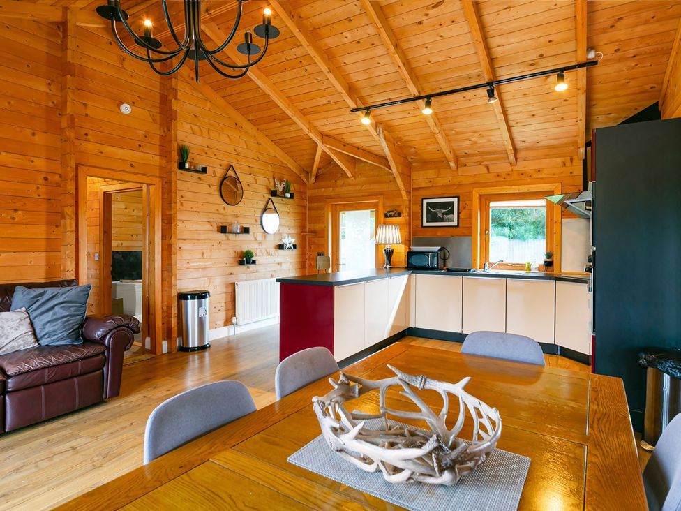 A living room with sofa and dining area at the property in location