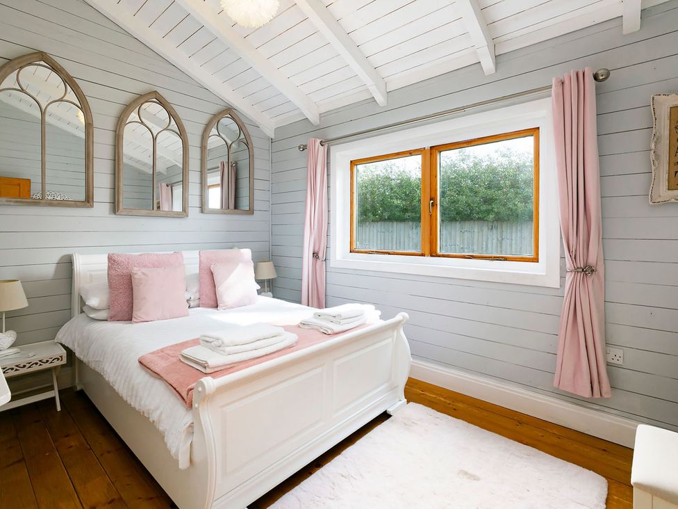 A bedroom with a bed and mirrors at 