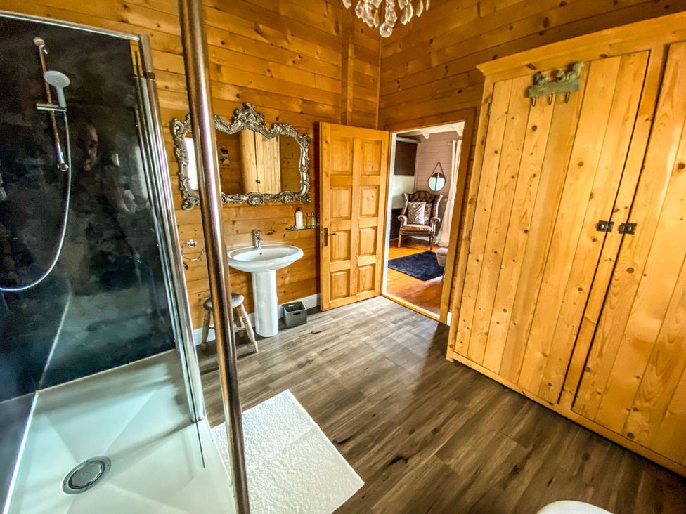 A bathroom with a shower, sink, and mirror at the property