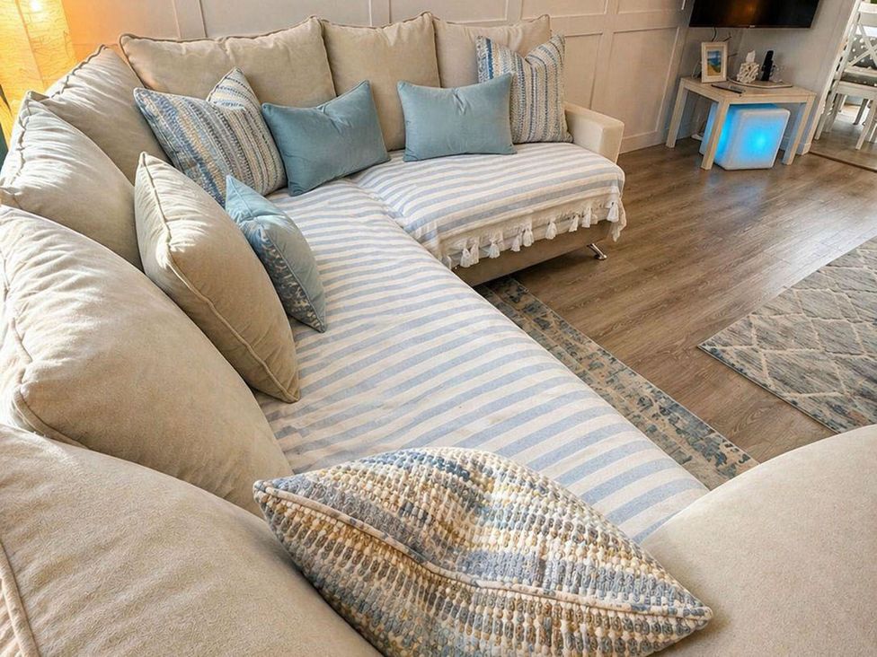A sectional sofa with throw pillows in a living room