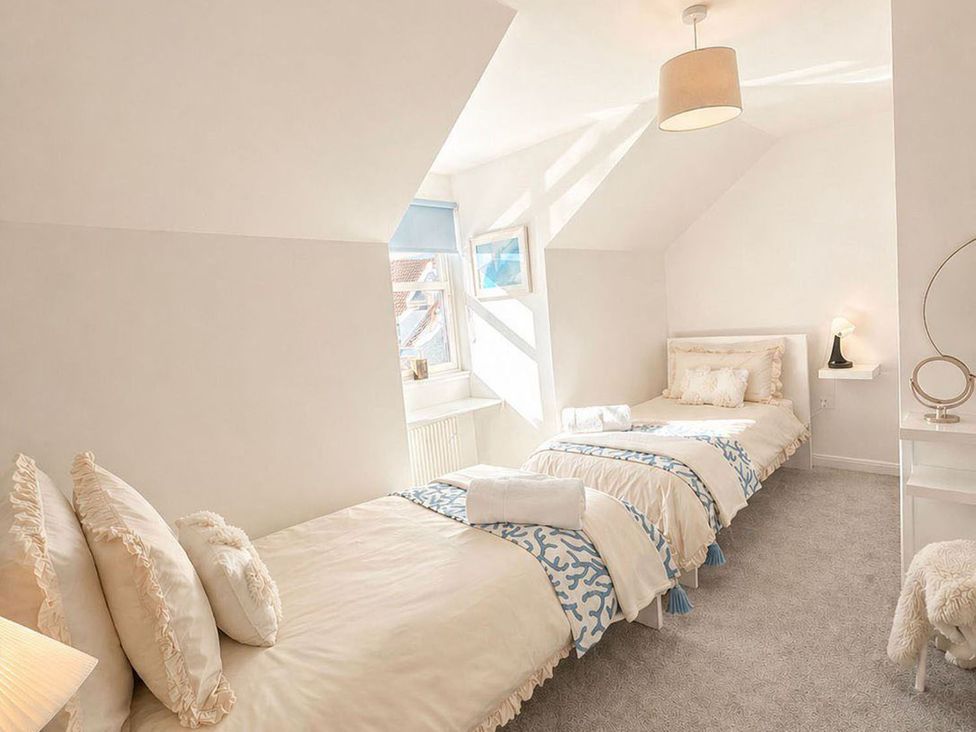 A bedroom with two beds and a lamp at the property in the location