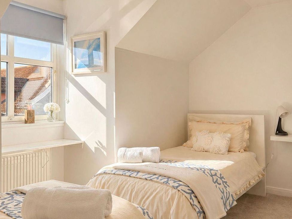 A bedroom with two beds and a window at The Old Barn in Manchester