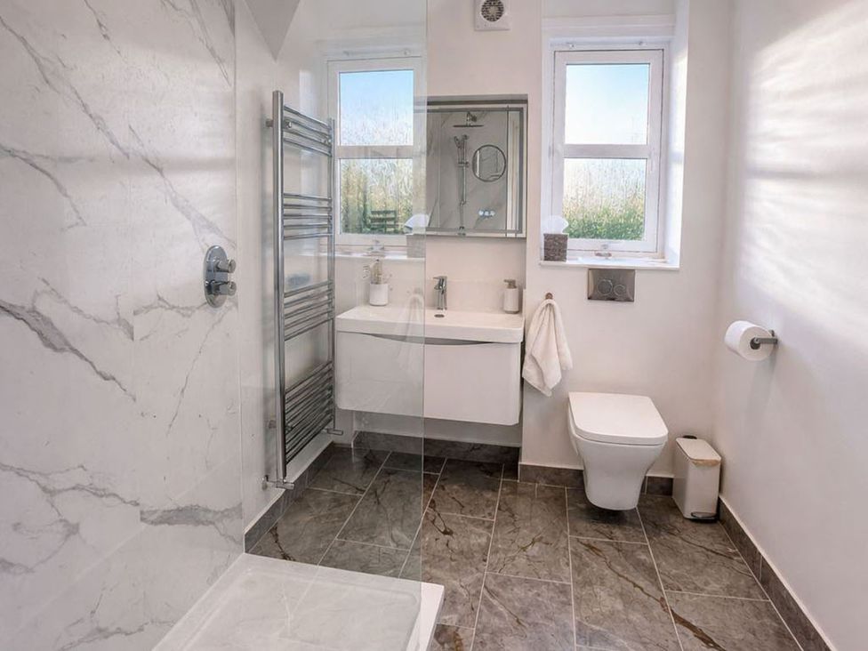 A bathroom with shower, sink, and toilet at the property in the location