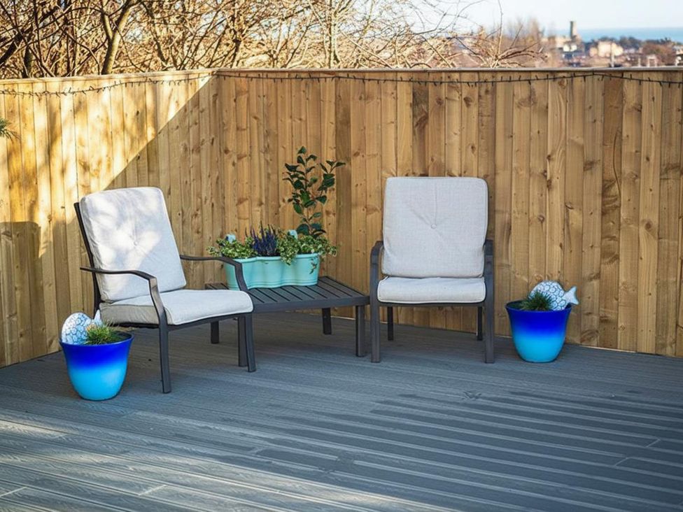 A seating area with two chairs and a table at outdoor patio