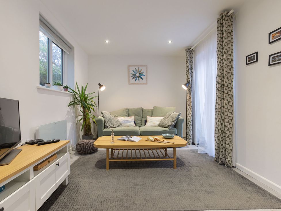 A living room with a sofa and coffee table at 1Bed Coastal Retreat Sleeps 2 Parking Wifi in Bude