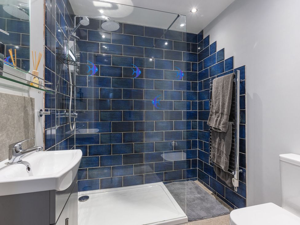 A bathroom with shower, sink, toilet and towel rack at 1Bed Coastal Retreat Sleeps 2 Parking Wifi Bude
