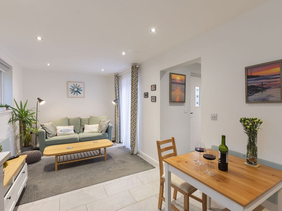 A living room with a sofa and dining table at 1Bed Coastal Retreat Sleeps 2 Parking Wifi, Bude