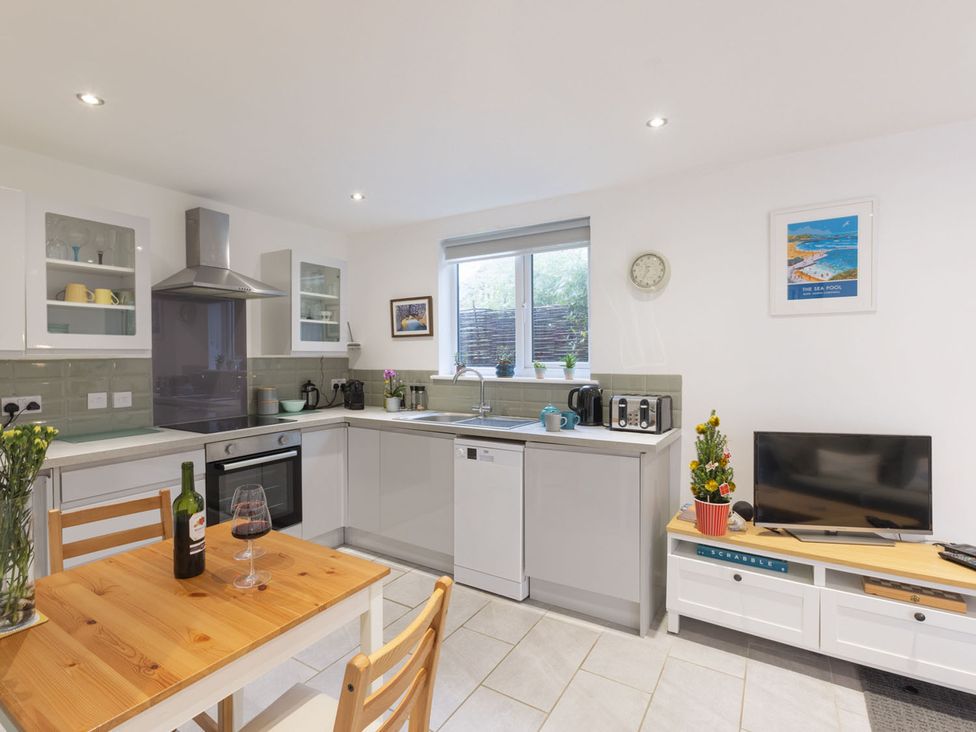 A kitchen with dining table and wine bottle at 1Bed Coastal Retreat Sleeps 2 Parking Wifi in Bude