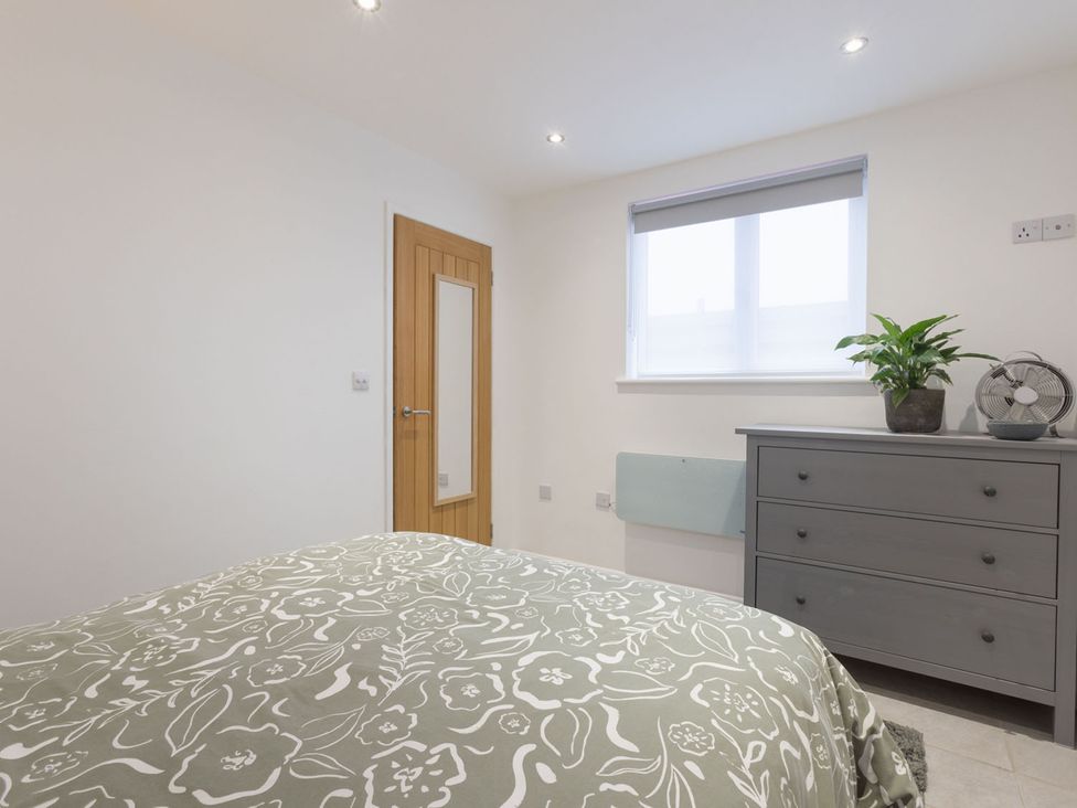 A bedroom with a bed and dresser at 1Bed Coastal Retreat Sleeps 2 Parking Wifi in Bude