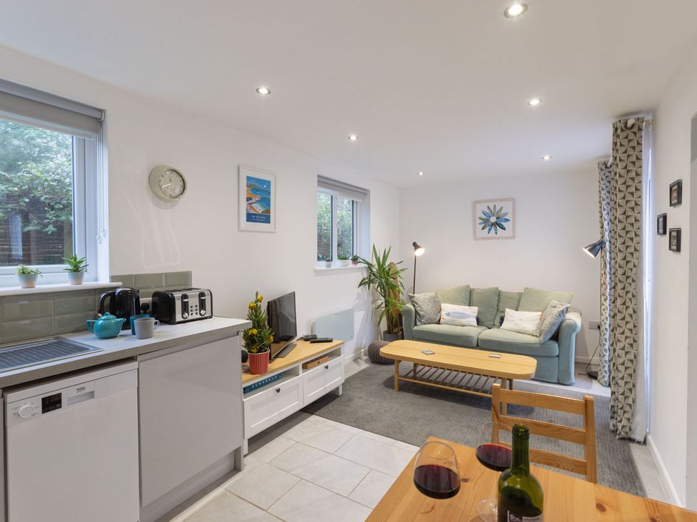 A living room with a sofa and dining table at 1Bed Coastal Retreat Sleeps 2 Parking Wifi in Bude