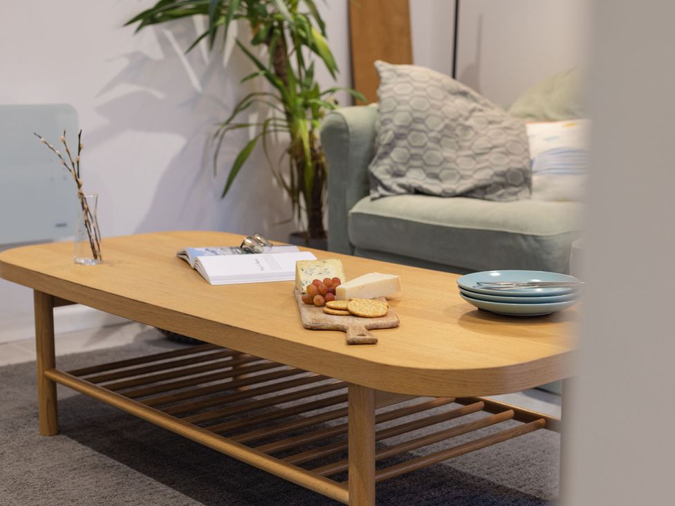 A coffee table with snacks and a plant in a living room at 1Bed Coastal Retreat Sleeps 2 Parking Wifi Bude