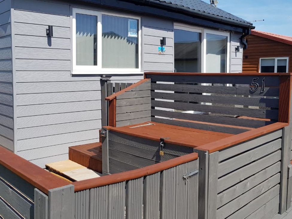 An outdoor area with a deck and railings at 51