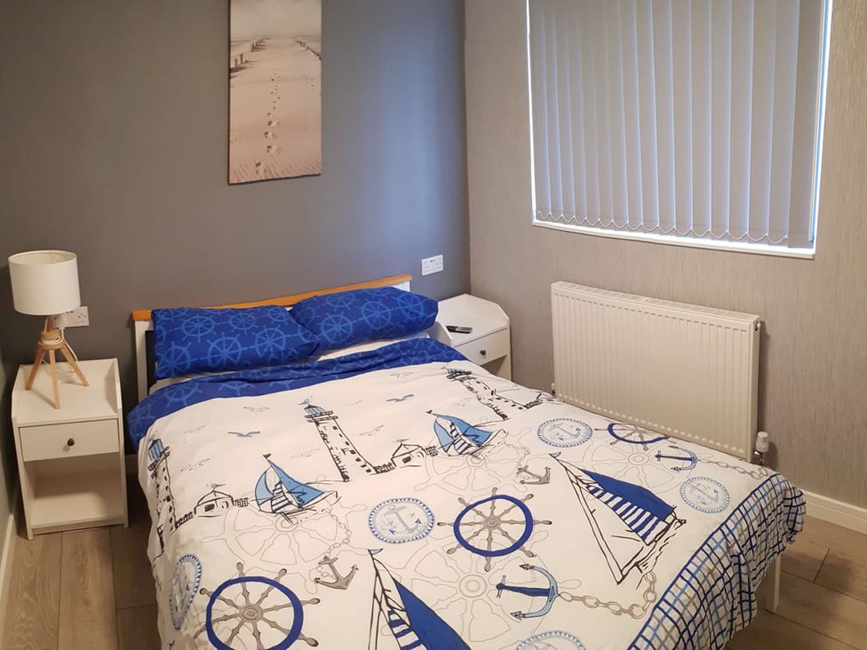 A bedroom with a bed and bedside table at The Old Barn in Manchester