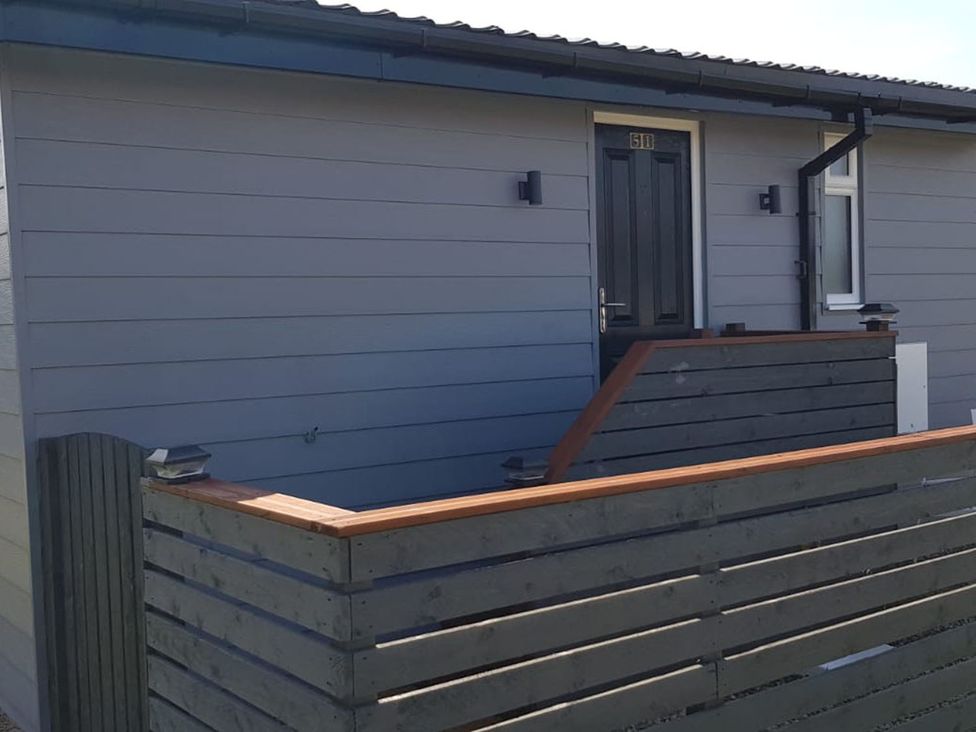 An outdoor area with a front door and steps at the property