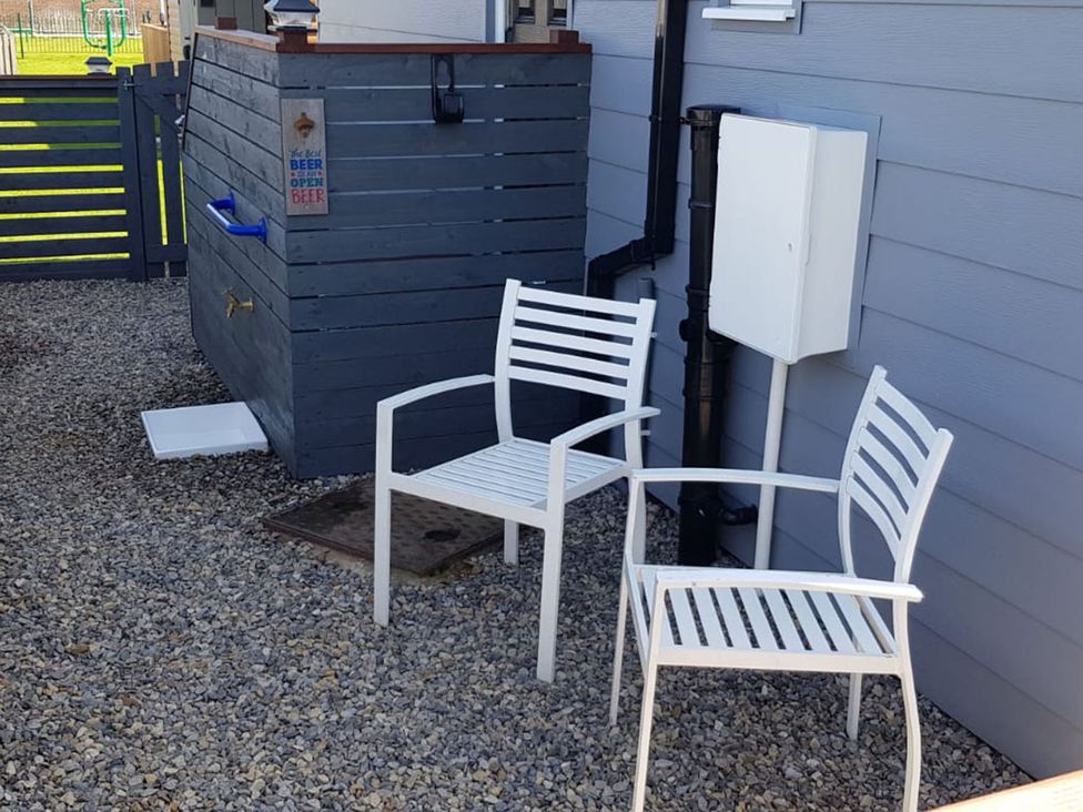 Two chairs and a storage unit in an outdoor area