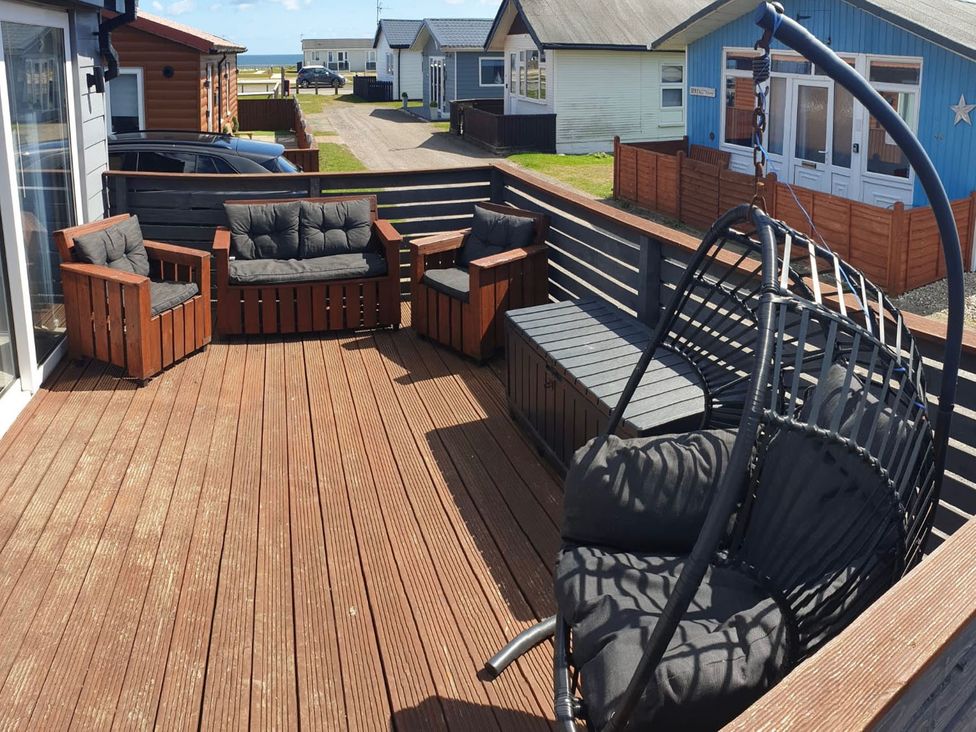 An outdoor seating area with furniture at a vacation rental in unspecified location