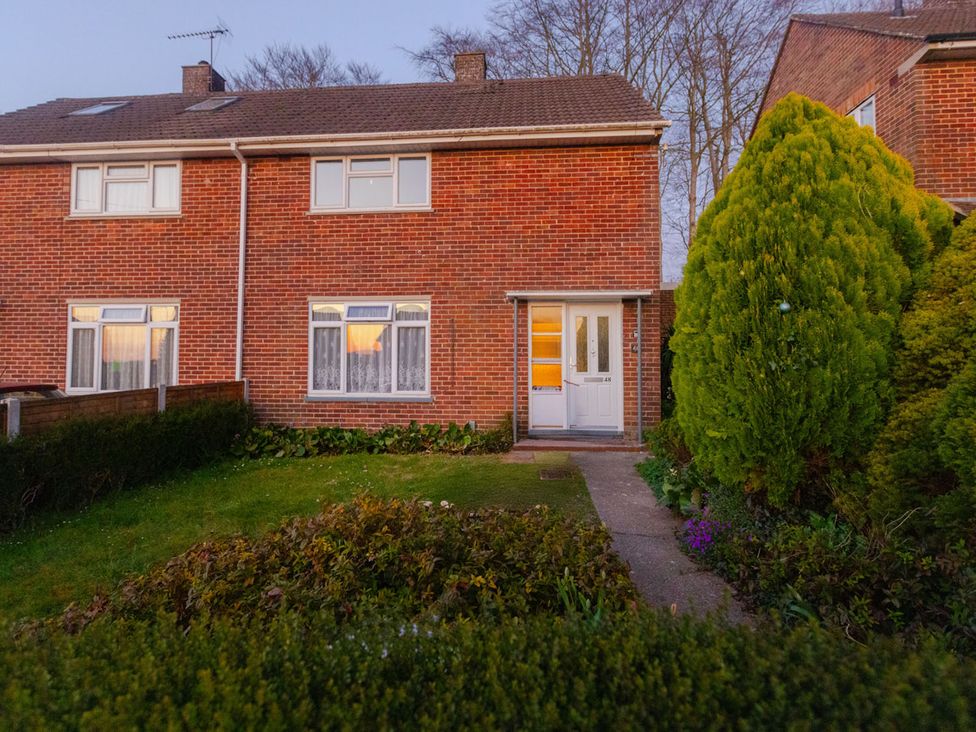 A house with a garden and pathway in front at a residential area