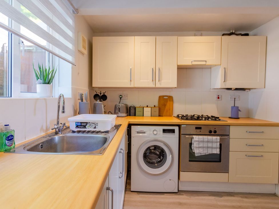 A kitchen with a washing machine and stove at 