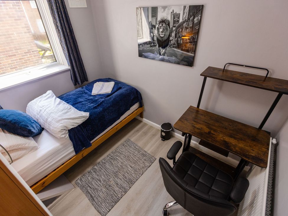 A bedroom with a bed and desk at The Old Barn in Manchester
