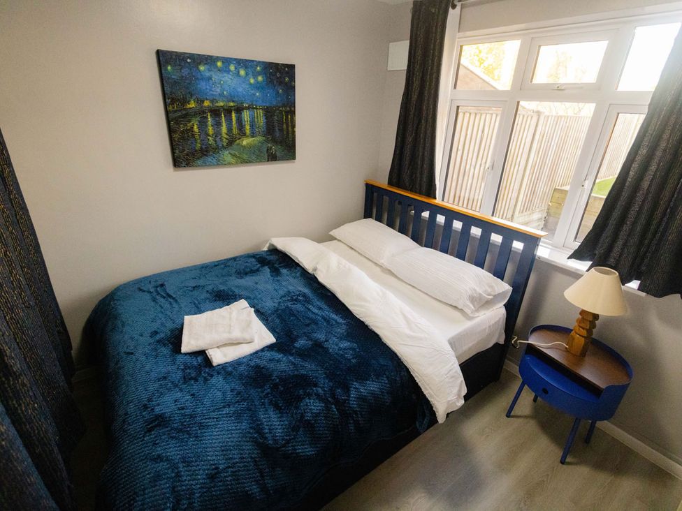 A bedroom with a bed and lamp at the property in location