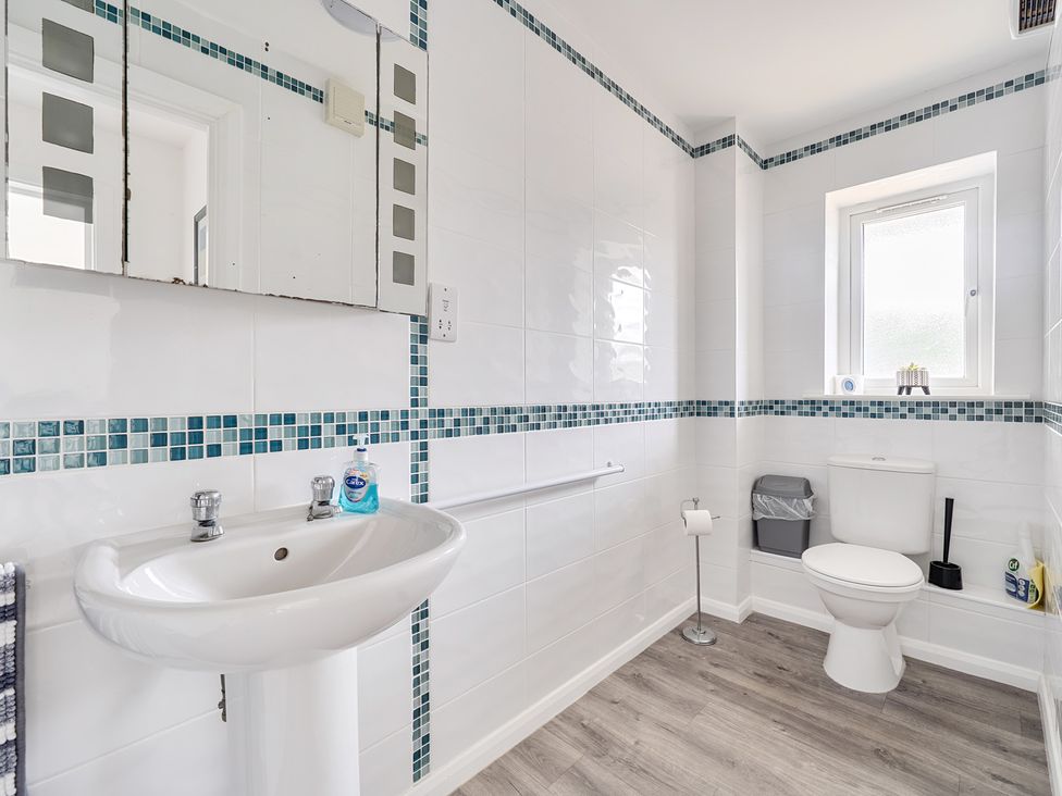 A bathroom with a sink and toilet at Spacious 3 Bed House Sleeps 6 Parking Wifi Newquay
