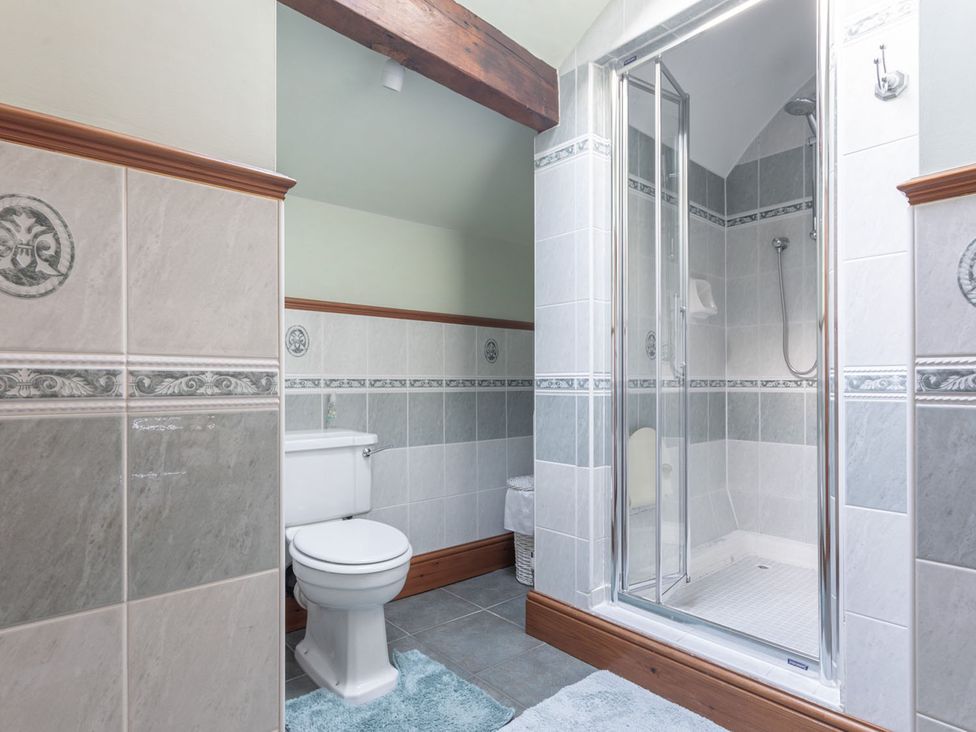A bathroom with a shower and toilet at Haworth Village House Sleeps 6 Parking Pets Cross Roads