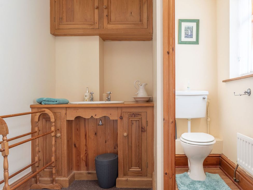 A bathroom with a toilet and sink at Haworth Village House Sleeps 6 Parking Pets in Cross Roads