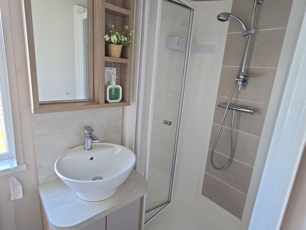 A bathroom with a shower and a sink at 2Br Lodge Pool Fireplace PetsOK Parking Goonhavern