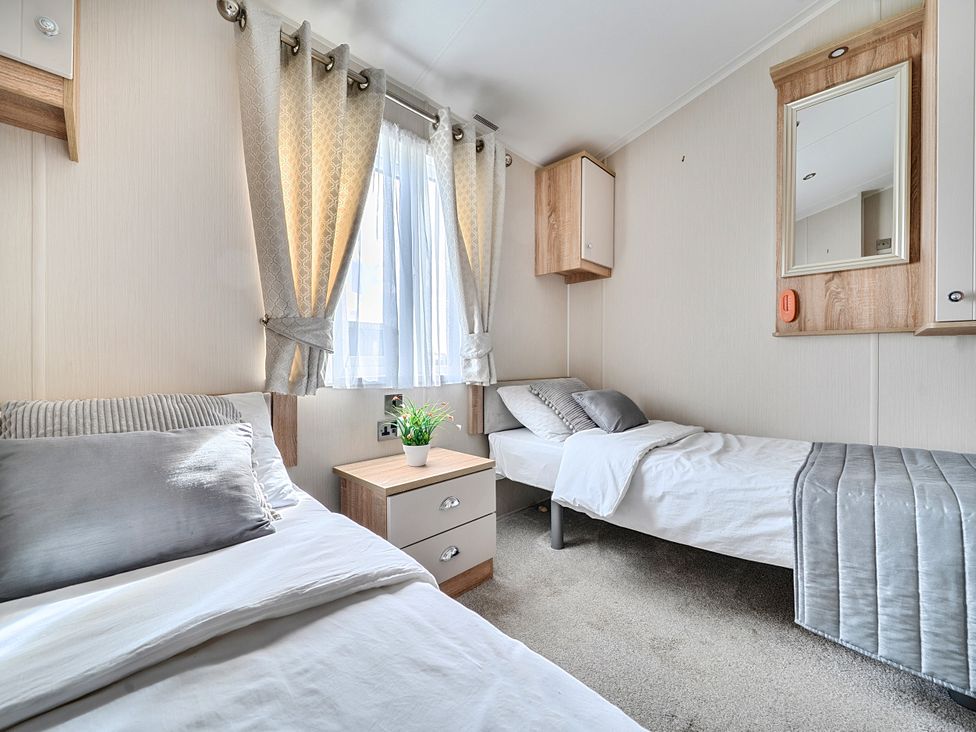 A bedroom with two beds and a bedside table at 2Br Lodge Pool Fireplace PetsOK Parking Goonhavern