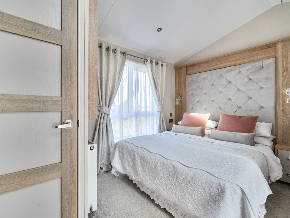 A bedroom with a bed and window at 2Br Lodge Pool Fireplace PetsOK Parking in Goonhavern