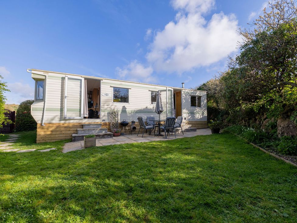 A mobile home with outdoor seating and grass area at Coastal Hideaway in Cornwall Dog Friendly Goldsithney