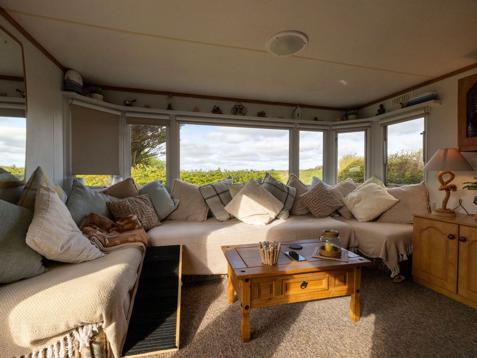 A snug with sofa and coffee table at Coastal Hideaway in Cornwall Dog Friendly Goldsithney