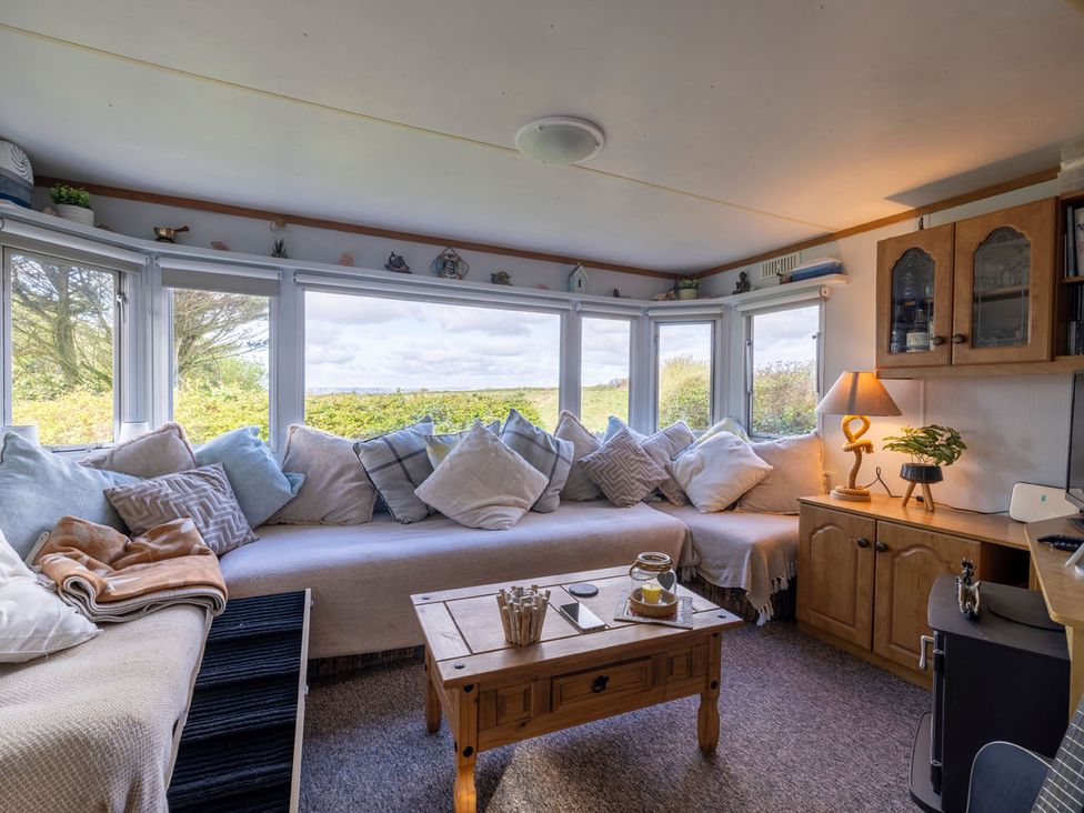 A snug with a sofa and coffee table at Coastal Hideaway in Cornwall Dog Friendly, Goldsithney