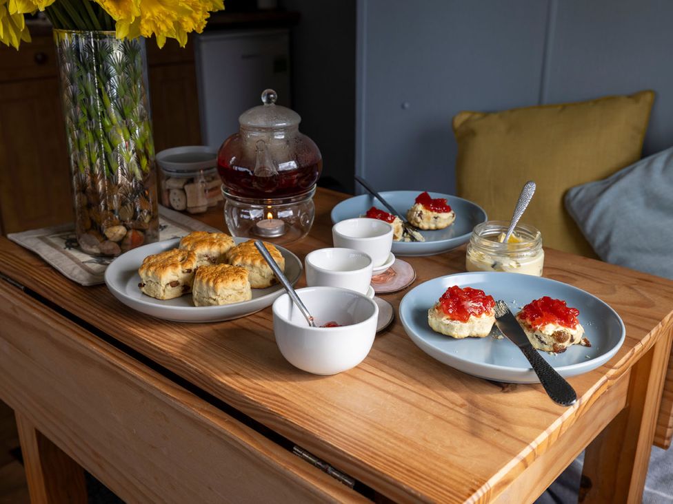 Scones with jam and cream on plates at Coastal Hideaway in Cornwall Dog Friendly, Goldsithney